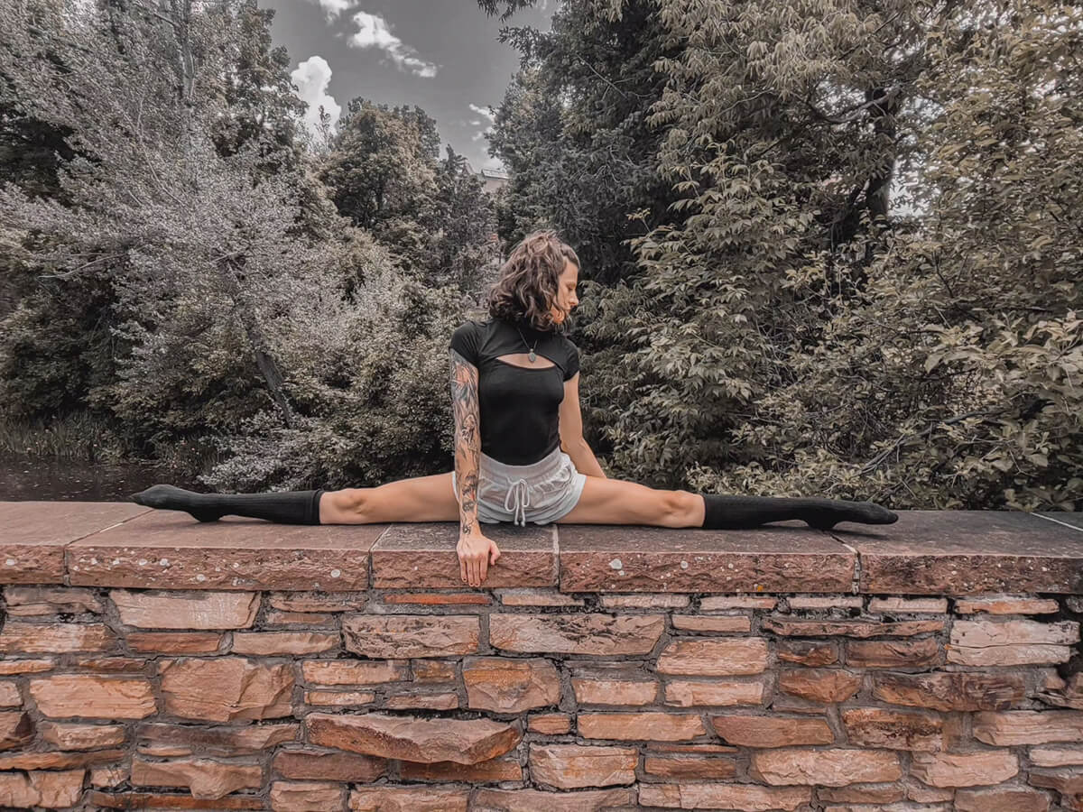 girl doing a middle split on a bridge